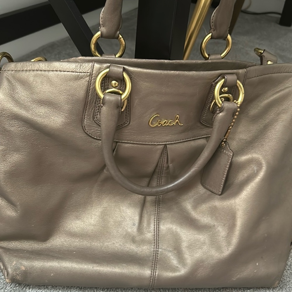 Coach leather bag with convertible strap.